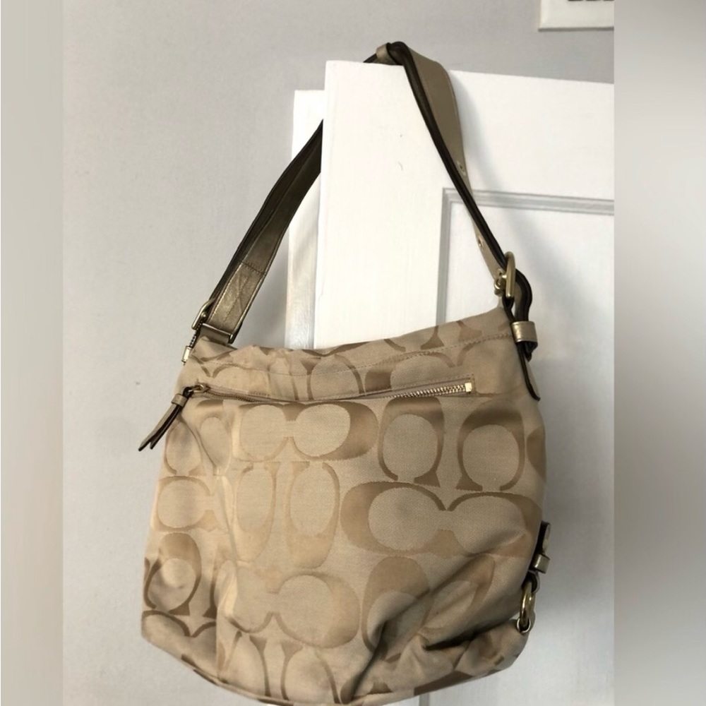 Coach tan handbag. Pink lining.